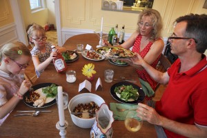 John Donohue, right, a food writer, havs dinner with his family at their home in New York last month. From left: Donohue’s daughters Aurora, 7, Isis, 5, and his wife, Sarah Schenck. (New York Times)