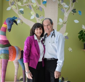 Diane and Robert Weiss in their decorated waiting room at Weiss Pediatric Care in Sarasota. [CREDIT: Dan Wagner, H-T staff]