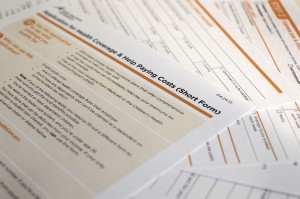 This April 30, 2013 file photo shows the short form for the new federal Affordable Care Act application in Washington. [CREDIT: J. David Ake, via The Associated Press]