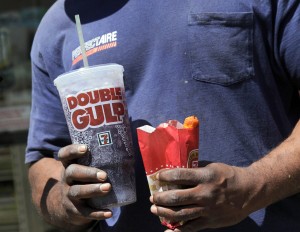 This 2012 file photo shows a man leaveing a 7-Eleven store with a Double Gulp drink in New York. [CREDIT: Richard Drew, via Associated Press file]