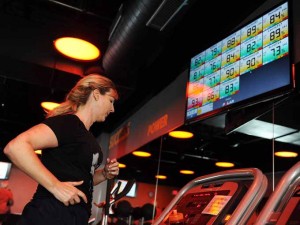 Angela Isaacman of Chantilly, Va., runs on the treadmill during an Orange 60 class at Orangetheory Fitness in Fairfax, Va.  (Washington Post photo by Matt McClain)