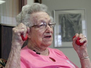 In this April 29, 2014 photo, Hildegard Gigl leads a twice weekly exercise class at Hawthorne Terrace independent retirement center in Wauwatosa, Wis. Gigl, who turns 99 in June, is the oldest one in the class. "I'm getting older but I'm not getting old," she says. (AP Photo/Carrie Antlfinger)