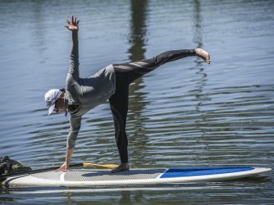 Jill Malusky does yoga on a standup paddleboard in the pond Saturday June 14, 2014 , at Shaker Village of Pleasant Hillnear,  Harrodsburg, KY. (AP Photo/The Advocate-Messenger, Clay Jackson) 