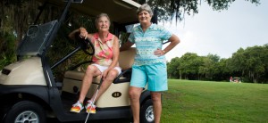 June Steck, left, and her partner Maria Ferraro, right, hang out on the 18th green at River Club in Lakewood Ranch where they live and play golf. Staying active has helped both women recover from joint surgery. (STAFF PHOTO / ELAINE LITHERLAND)