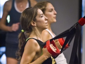 Kari Saitowitz, owner of the Fhitting Room boutique fitness studio, workout with a class at one of gym's three New York locations. Saitowitz was a marketing executive before she quit to raise her two children. After taking high intensity training classes she decided to open a studio of her own.  (AP Photo/Bebeto Matthews)