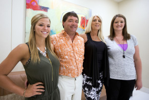 Dean DeMoe, second from left, with his family, from left, daughter McKenna DeMoe, 19, wife, Deb Demoe, and daughter Lindsey Sarkilahti, 29, pose for a picture at the Alzheimer's Association International Conference in Washington, Saturday, July 18, 2015. Alzheimer's has ravaged generations of Dean DeMoe's family _ his grandmother, father, siblings _ all in their 40s and 50s. DeMoe, too, inherited the culprit gene mutation and at 53, the North Dakota man volunteers for a drug study he hopes one day will end the family's burden.  (AP Photo/Manuel Balce Ceneta)