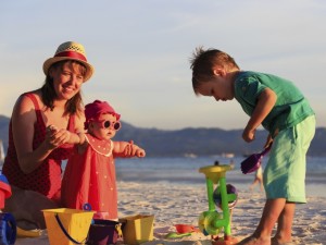 mother with kids on tropical beach vacation