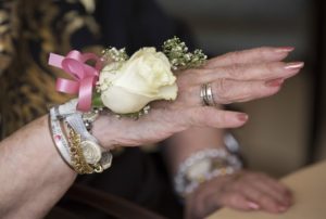 A resident of the Hebrew Home at Riverdale wears a corsage to its senior prom, in the Bronx borough of New York. Nursing homes across the country are increasingly supportive of residents pursuing intimate relationships; Hebrew Home has had a formal sexual expression policy since 1995. PHOTO/NYT